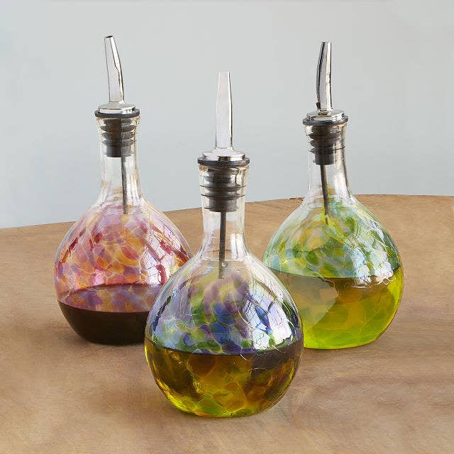 Three handblown glass olive oil pourers in Sunrise Pink, Twilight Blue and Seaside Green