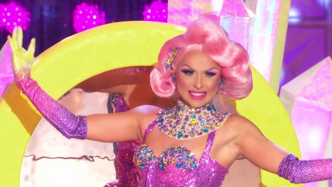 Drag queen Farrah Moan wearing a heavily jeweled yellow and pink burlesque outfit