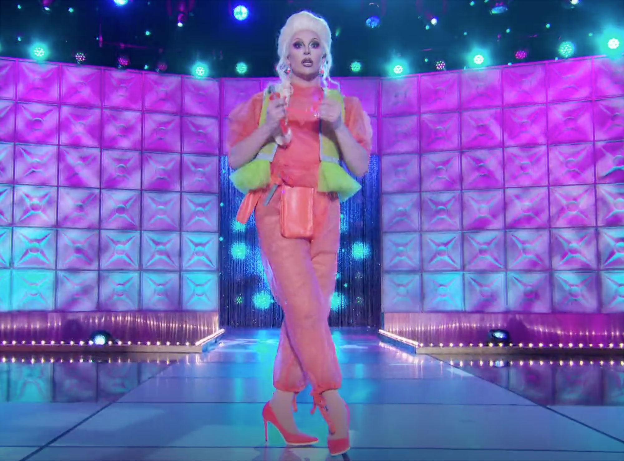 Drag queen Jan dressed in a neon orange and yellow tulle construction style outfit