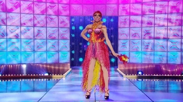 Drag queen Yvie Oddly wearing a dress in warm colours made from dried flowers