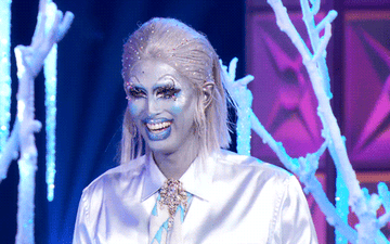 Drag queen Crystal Methyd wearing a glamorous tailored silver costume inspired by Arnold Schwarzenegger&#x27;s Mr. Freeze