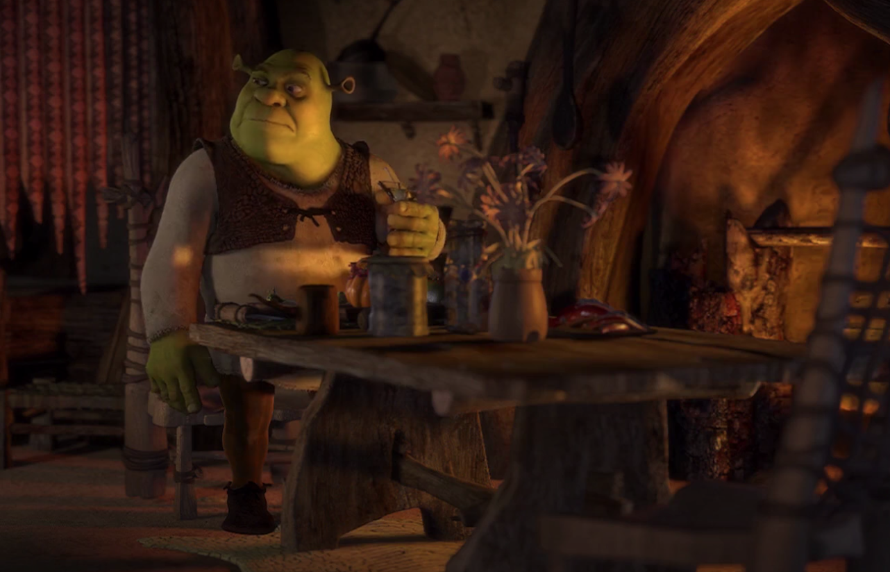 Shrek sitting alone at his table eating 