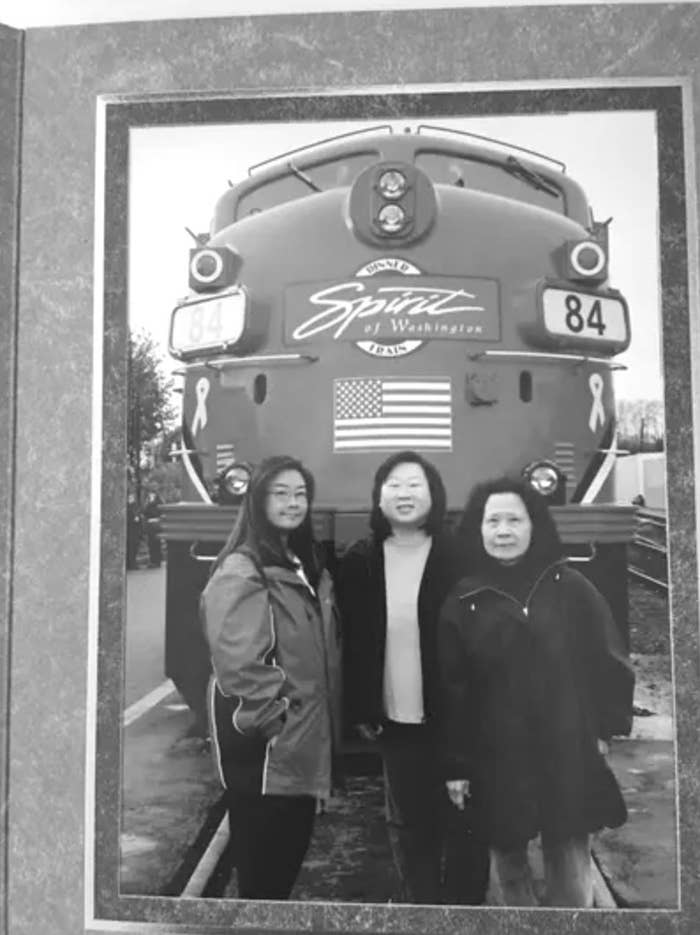 The Lee family poses in front of a train