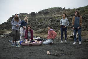 The teen girl cast of "The Wilds" stranded on the beach they now call home