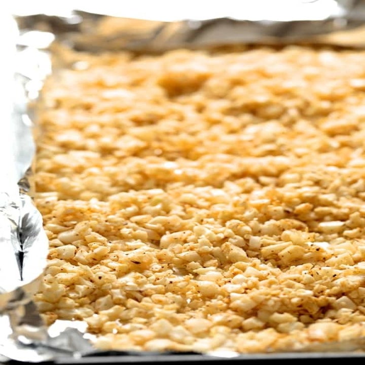 Cauliflower rice on a baking sheet.