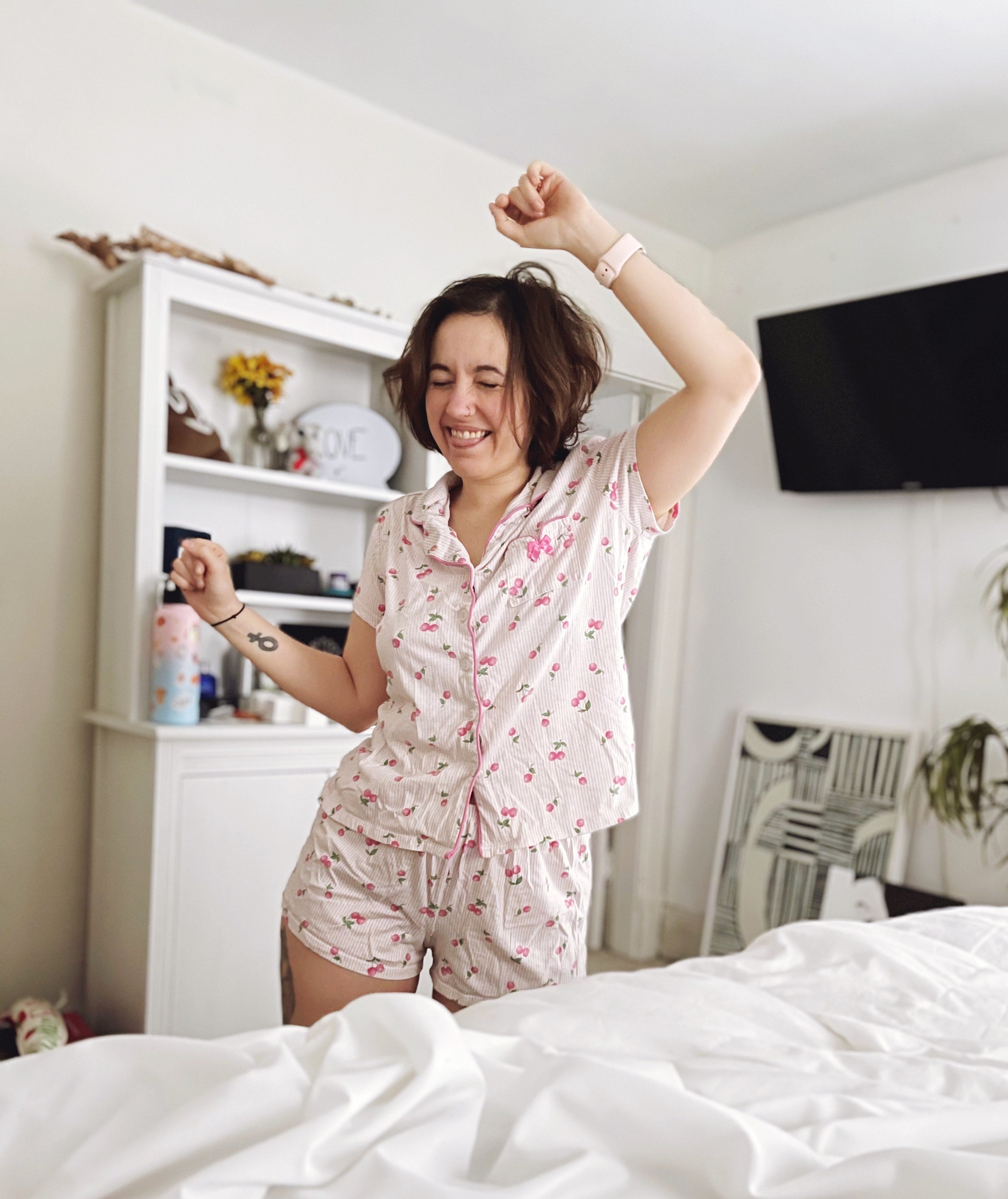 Person is dancing next to a bed