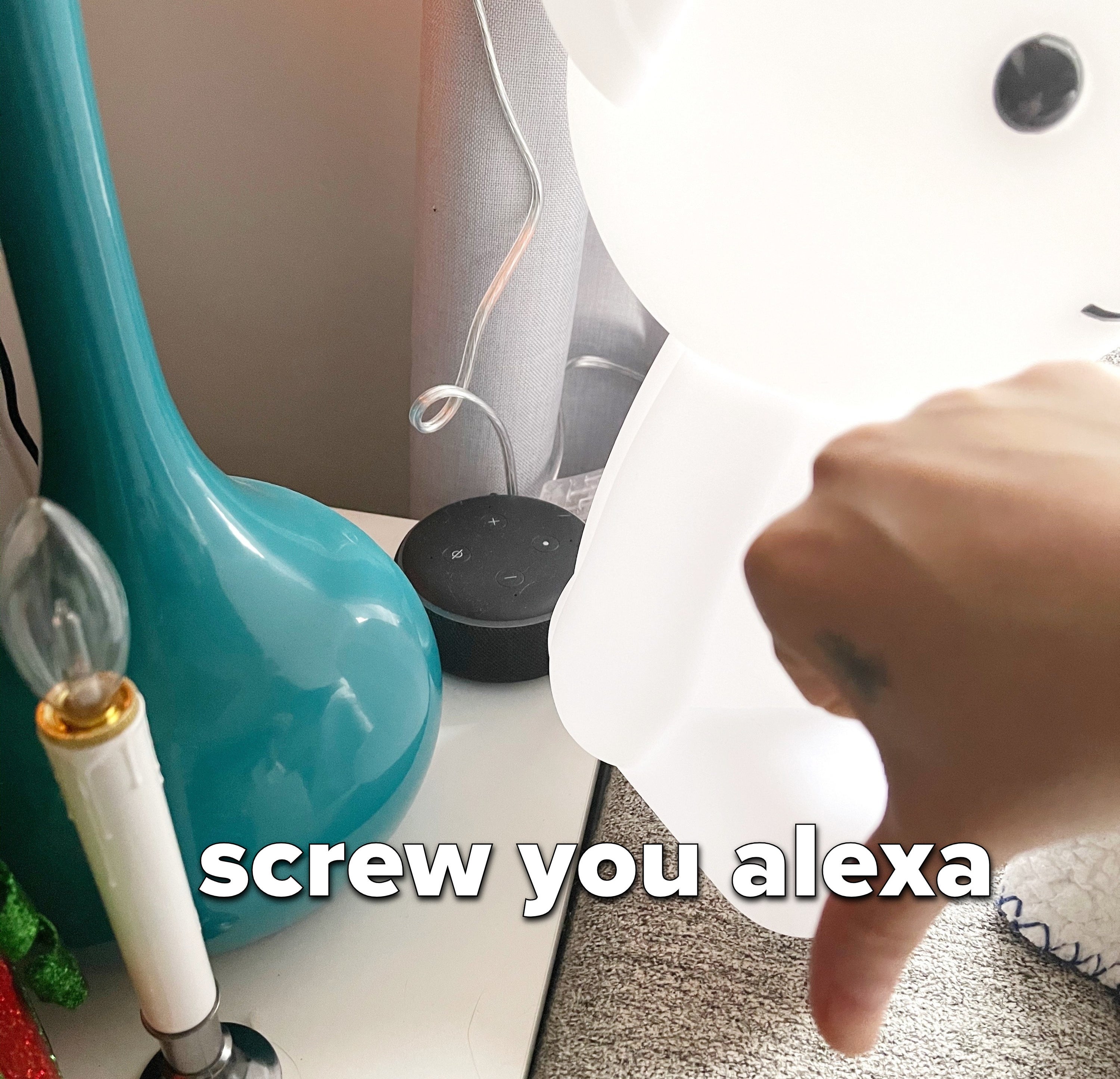 Person with a thumbs-down in front of an Amazon Echo