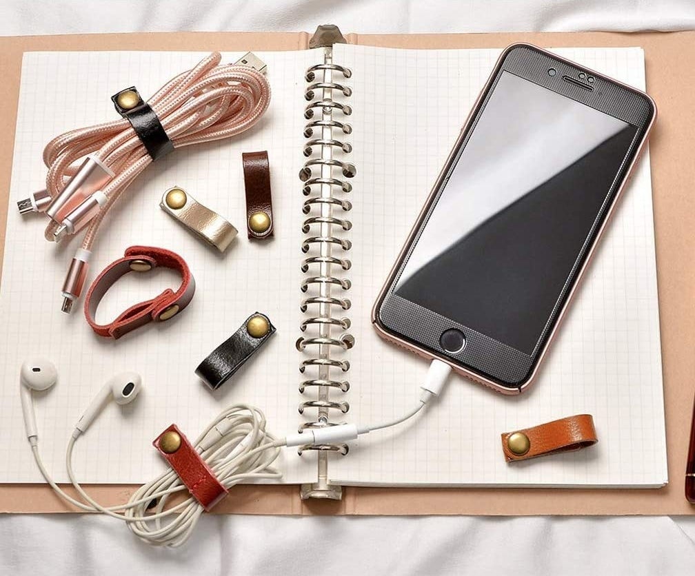 Several cord ties laid out on a book, some are attached to cables