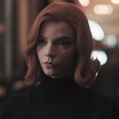 A closeup of Beth; she is wearing a black turtleneck