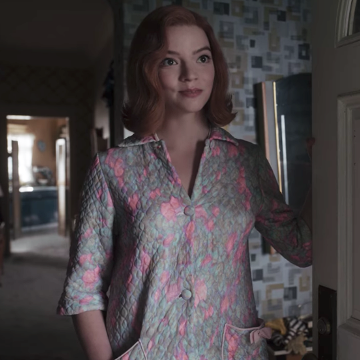 Beth wearing the same dress that her mother used to wear before she died; it is long-sleeved, collared, coloured pale blue and pink and has a floral print with pockets