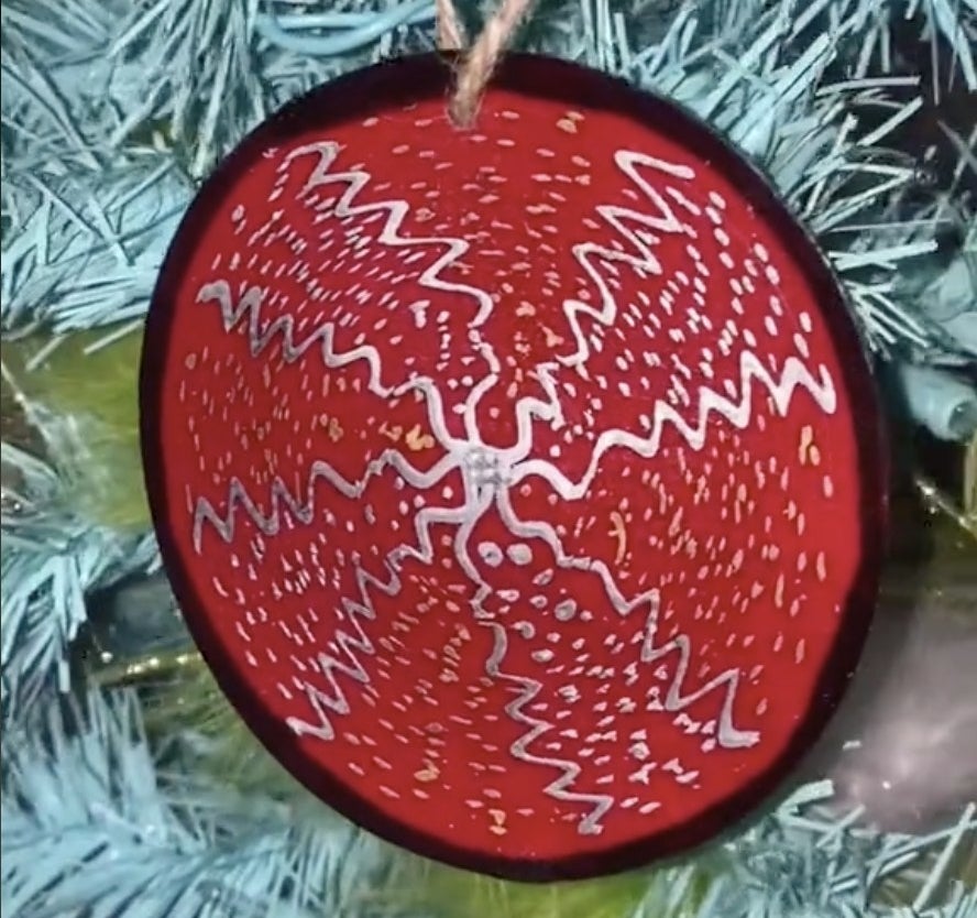 A red ornament with a spiral design
