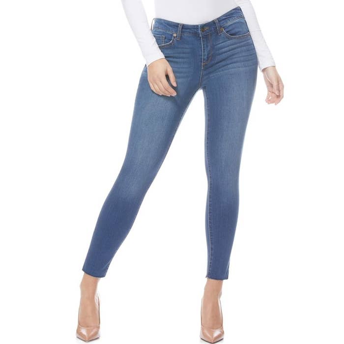 model wears medium wash skinny jeans 