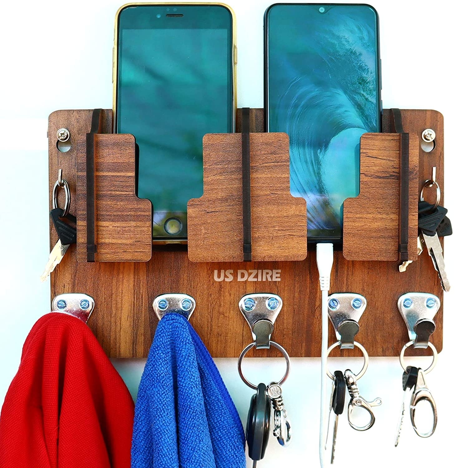 A brown MDF wall organiser with keys, napkins and two phones