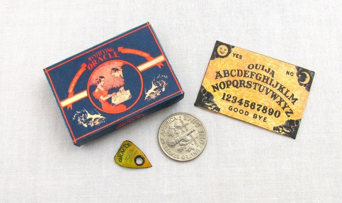 small oujia board with box and planchette