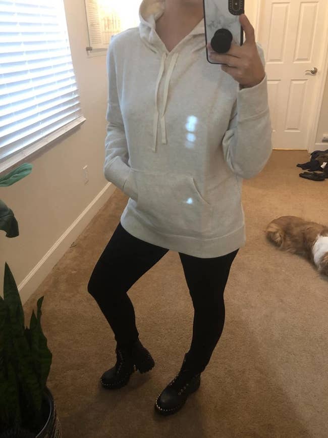 Reviewer wearing white Amazon Essentials pullover hoodie