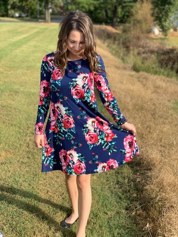 Reviewer wearing floral navy blue T-shirt dress