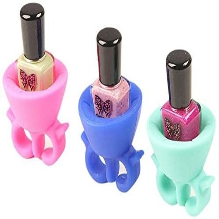Three silicone rings with nail polish bottles in the center