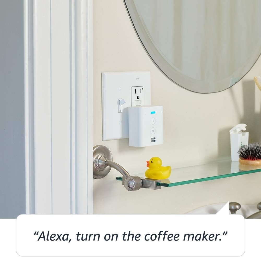 Echo Flex plugged into an outlet in a bathroom next to a rubber ducky 