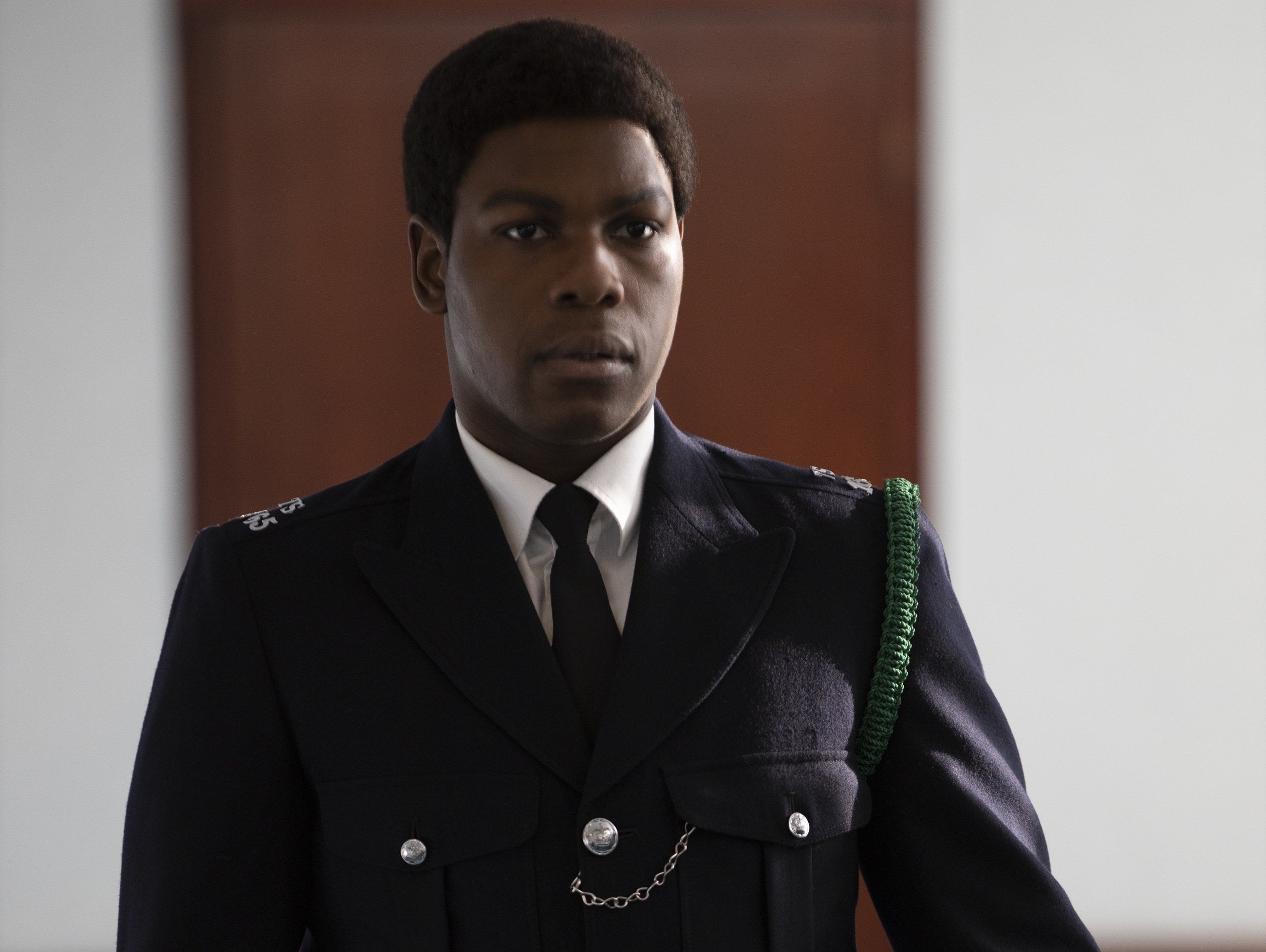 John Boyega dressed in a cop uniform in a scene from &quot;Red, White and Blue&quot;