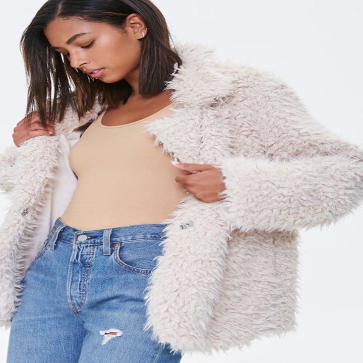 a model ina. white faux fur jacket