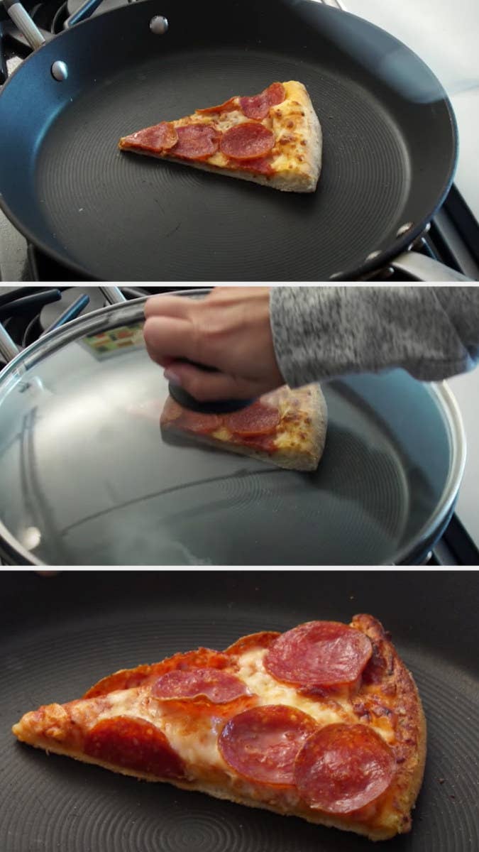 Someone heating up a small slice of pepperoni pizza in a pan on a stovetop with a lid