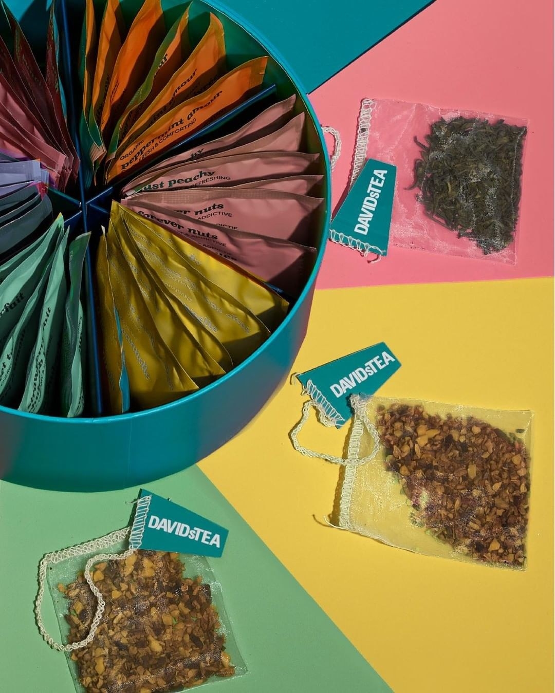 A circular box filled with sachets of tea blends