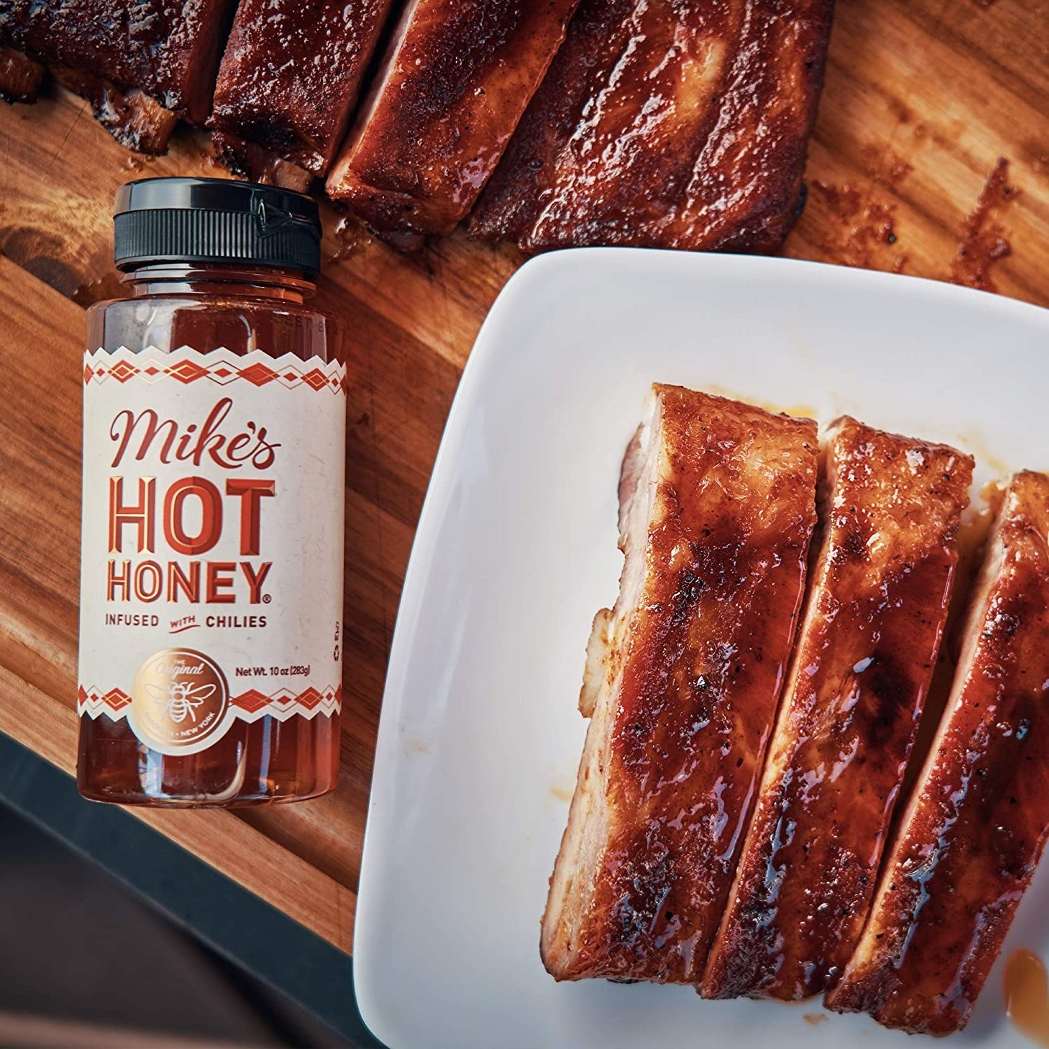 bottle of Mike&#x27;s Hot Honey next to ribs