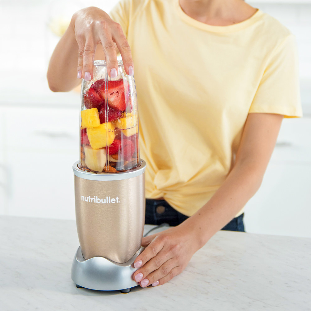 Person using the mini blender to make a smoothie 