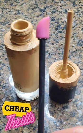 A reviewer's photo of the small spatula in front of a foundation bottle