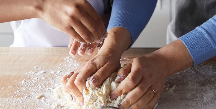 hands kneading dough