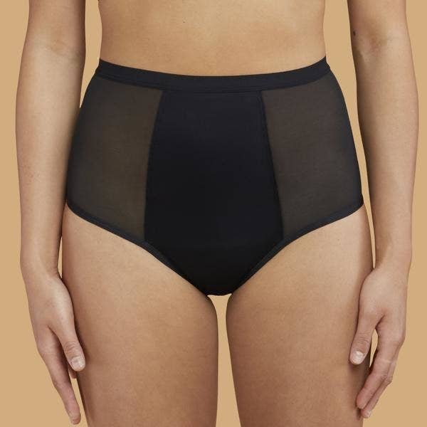 A model wearing the black Super Hi-Waist underwear which have mesh sides 