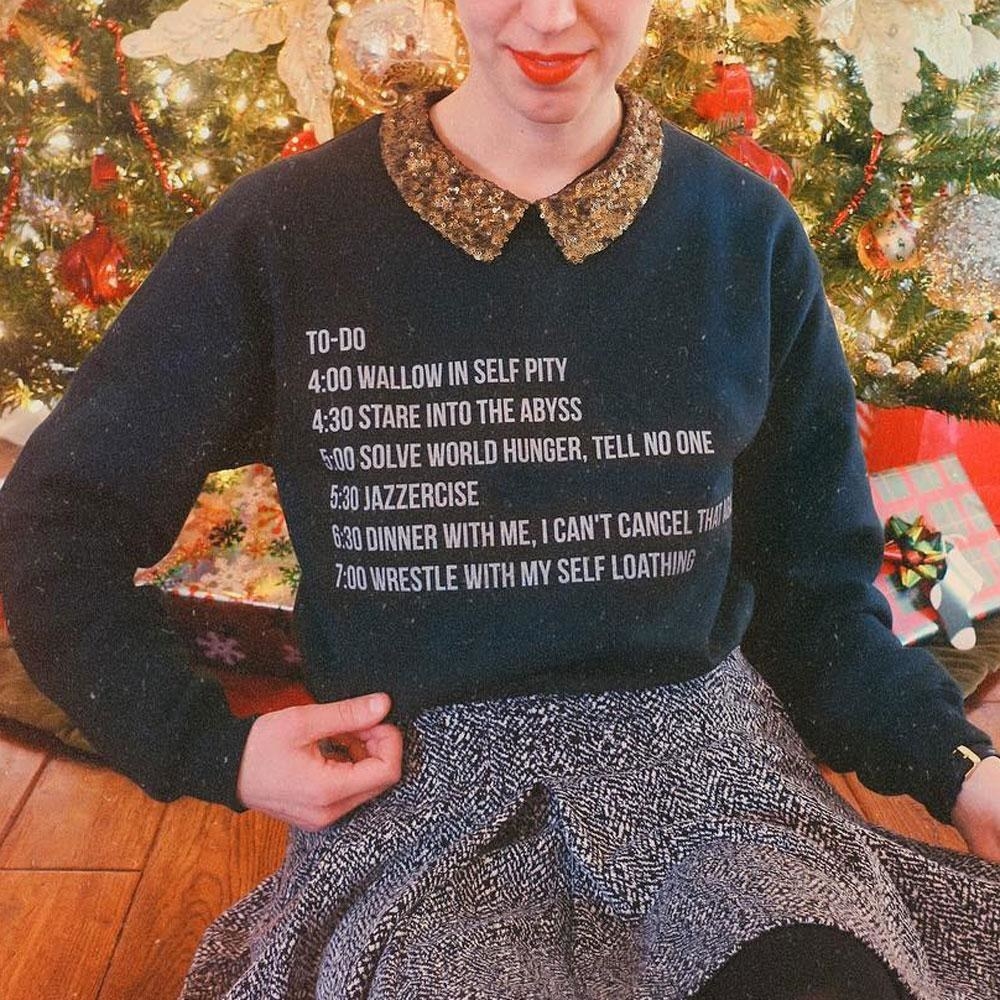 person wearing sweater with quote from &quot;The Grinch&quot;