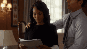 Fitz hugging and kissing Olivia from behind. 