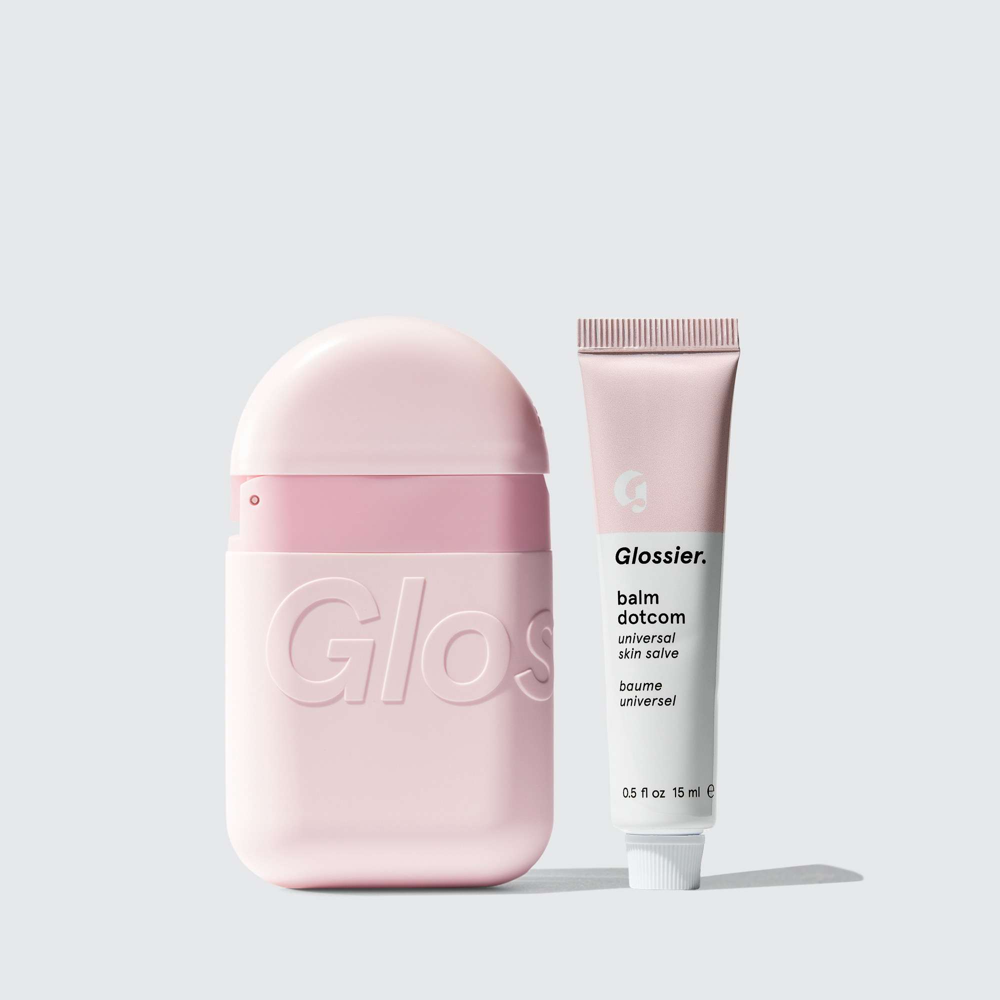 The Nightstand Duo with a pink Hand Cream container and a pink and white tub of Glossier Balm Dotcom