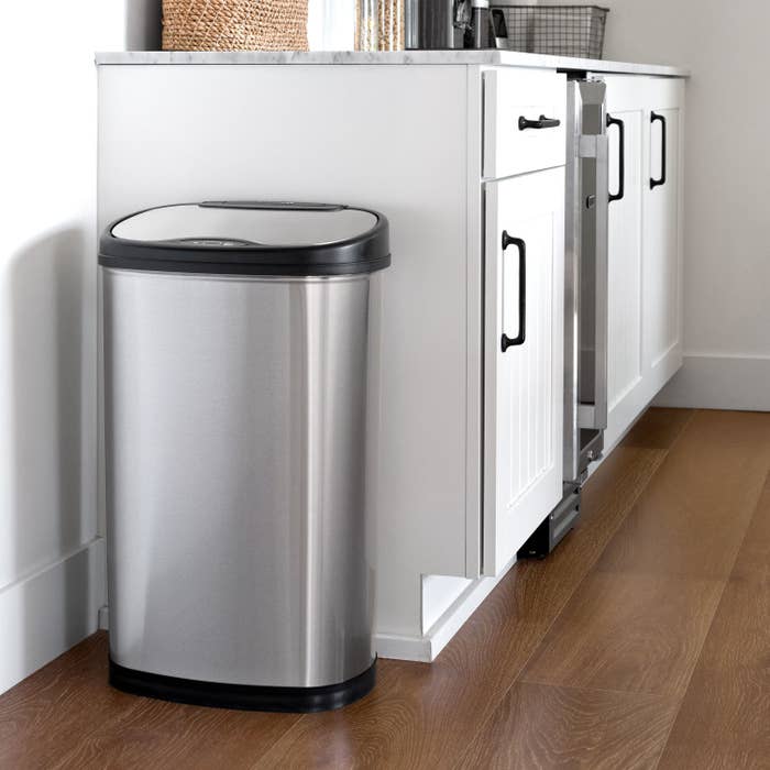 The silver trash can in a kitchen