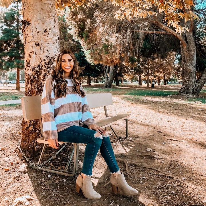 reviewer wearing the sweater with jeans 