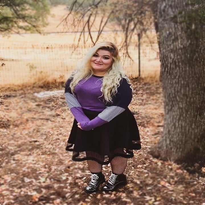 reviewer wearing top in purple with skirt 