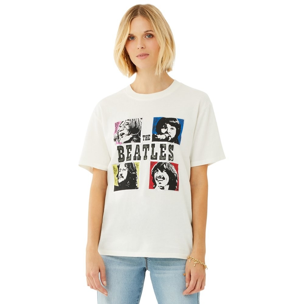 model wears white graphic t-shirt with beetles members on it. 
