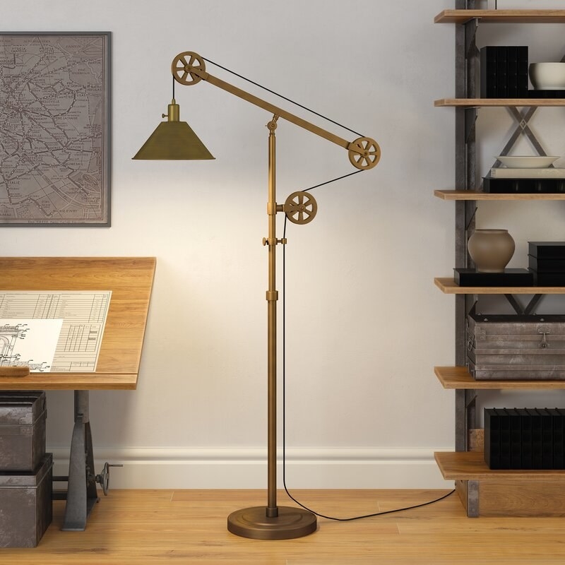 The lamp, which has a metal shade, and three pulleys used to adjust the height of the bulb