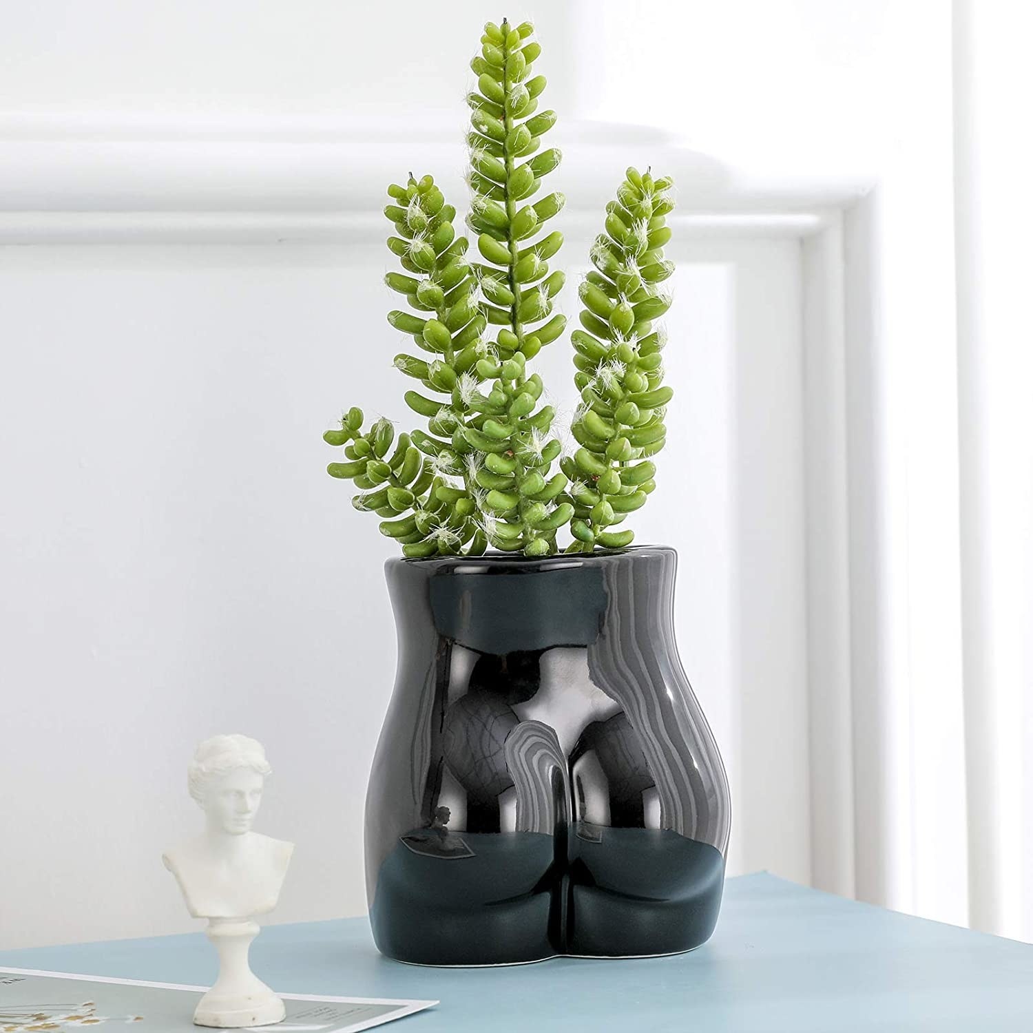 black flower vase shaped like a butt
