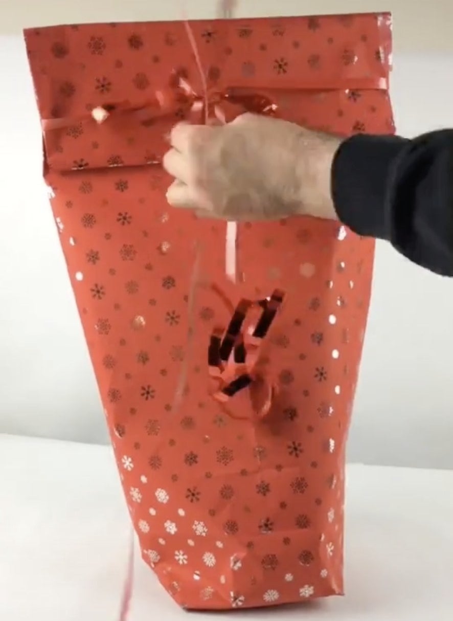 Red wrapping paper that has been folded to become a bag