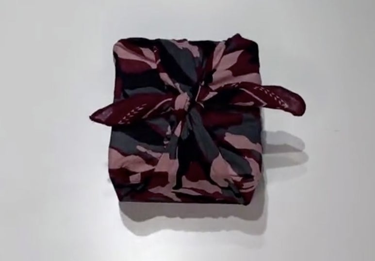 A present wrapped in a red camo print bandana