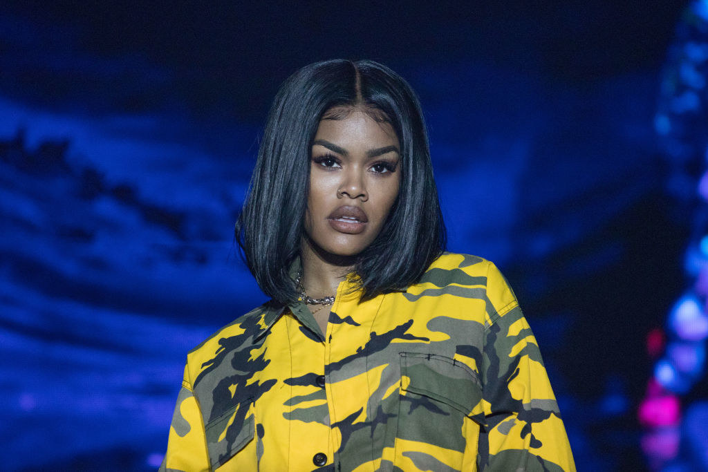 Teyana in a camo-style shirt