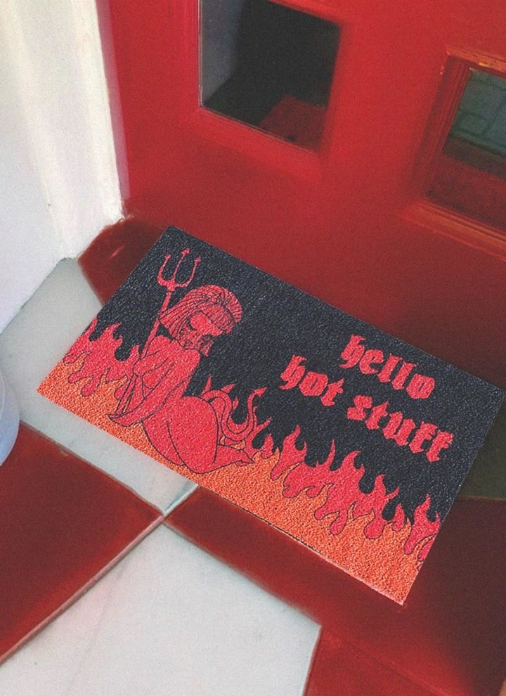 black doormat with fire and devil that says hello hot stuff