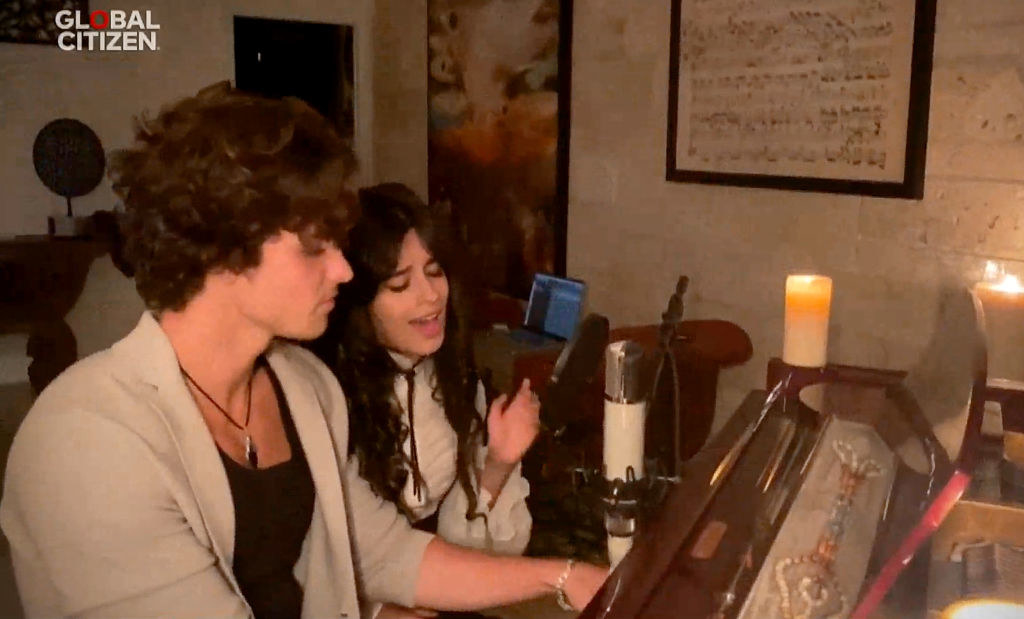 Shawn and Camila singing at a piano
