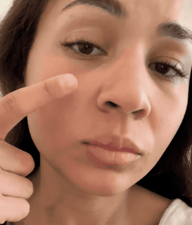a gif of a buzzfeed employee putting cloud paint on their cheeks