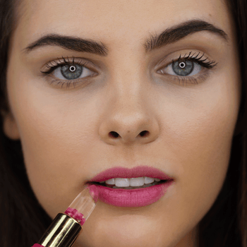 a gif of a model putting the lip balm on