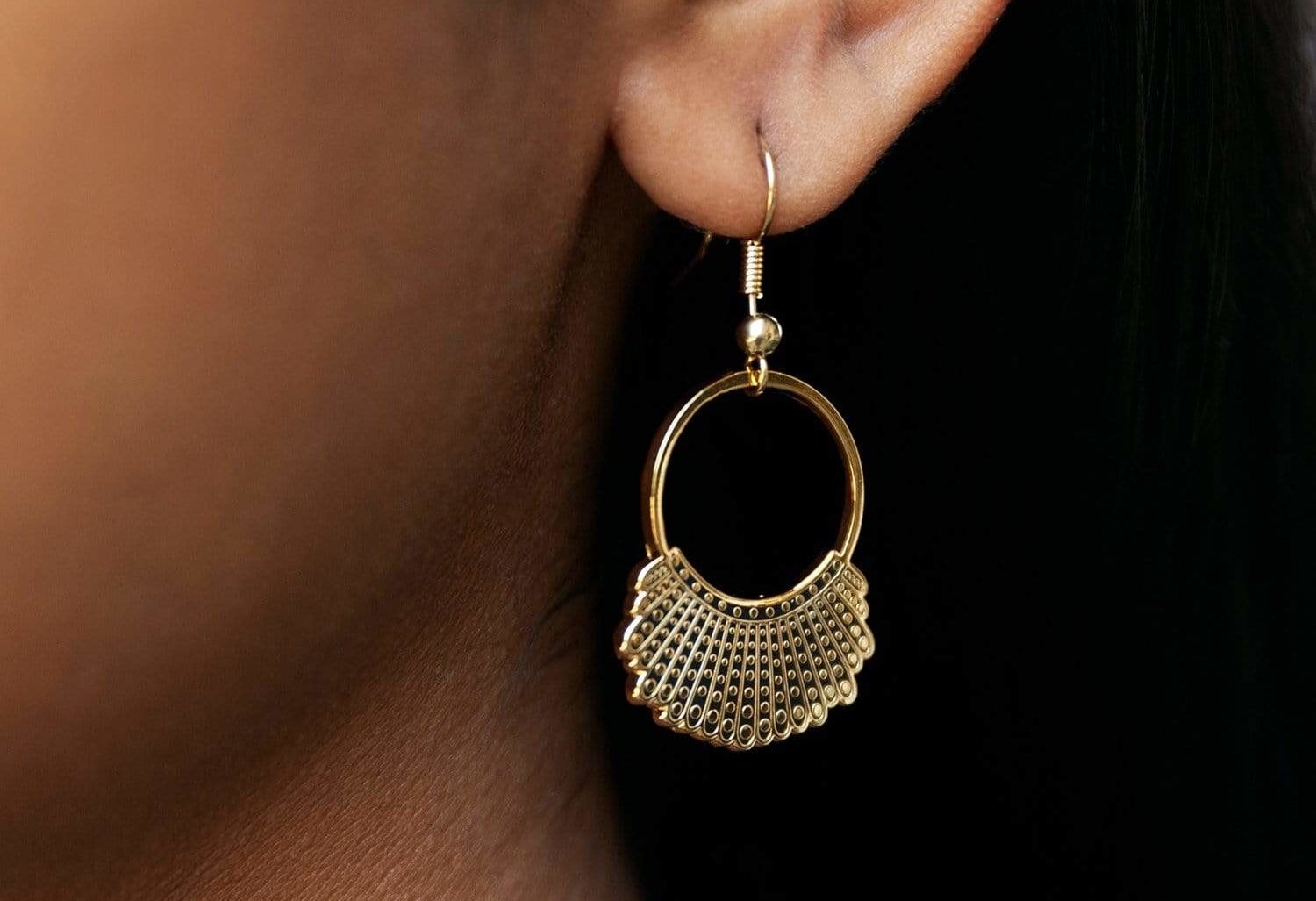 Model wearing gold plated hook and hoop earrings