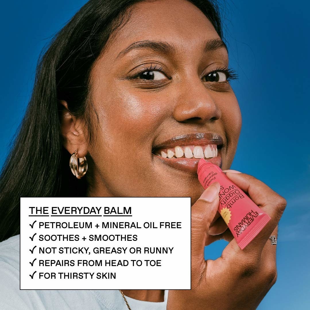 person putting the balm on their lips 