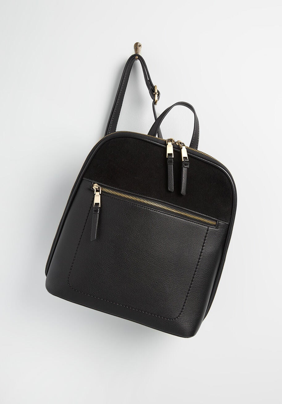 flat backpack with large zippered front pocket that takes up majority of the front of the bag 